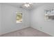 Bright bedroom featuring neutral colored carpet and two windows looking out into the yard at 1593 Westwood Dr, Charleston, SC 29412