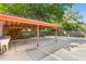 Carport and utility sink behind the home, with mature trees and a wood fence at 1593 Westwood Dr, Charleston, SC 29412