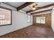 Bright living room features hardwood floors, ceiling beams, and paneled walls at 1593 Westwood Dr, Charleston, SC 29412