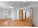 Bright living room featuring hardwood floors, fresh paint, and an adjoining room via wood paneled doors at 1593 Westwood Dr, Charleston, SC 29412