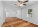 Bright living room featuring hardwood floors, ceiling fans, and a hallway at 1593 Westwood Dr, Charleston, SC 29412