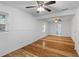 Bright living room featuring hardwood floors, ceiling fans, and a view of the bathroom at 1593 Westwood Dr, Charleston, SC 29412