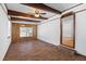 Bright living room features hardwood floors, ceiling beams, and a doorway to another room at 1593 Westwood Dr, Charleston, SC 29412