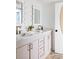 Stylish bathroom featuring dual sinks, a light pink vanity, and decorative mirrors at 1634 Live Oak Park, Seabrook Island, SC 29455