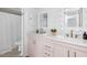 Elegant bathroom with dual sinks, light pink vanity, and classic gold fixtures at 1634 Live Oak Park, Seabrook Island, SC 29455