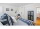 Bright bedroom featuring a comfortable bed, decorative wall art, and a rustic sliding barn door at 1634 Live Oak Park, Seabrook Island, SC 29455