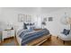 Serene bedroom with blue and white bedding, complemented by stylish wall art and a wooden bench at 1634 Live Oak Park, Seabrook Island, SC 29455