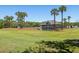 Lush grounds surround an attractive modern home with plenty of palm trees and a green lawn at 1634 Live Oak Park, Seabrook Island, SC 29455
