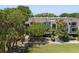 Exterior of townhouses showcasing a landscaped courtyard and multiple levels of living at 1634 Live Oak Park, Seabrook Island, SC 29455
