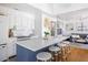 Bright kitchen with a large island, white cabinets, and a cozy living area at 1634 Live Oak Park, Seabrook Island, SC 29455