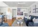 Bright living room with blue sofa, stylish nautical accents, and convenient kitchen access at 1634 Live Oak Park, Seabrook Island, SC 29455