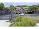 Community tennis court with a shaded spectator area and mature landscaping at 1634 Live Oak Park, Seabrook Island, SC 29455