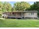 Home exterior with a spacious backyard and deck at 1671 Dawson Branch Rd, Summerville, SC 29483