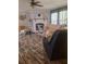 Cozy living room with stone fireplace, wood-look floors, comfortable seating, and bright windows at 1671 Dawson Branch Rd, Summerville, SC 29483
