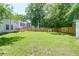 Spacious backyard featuring well-maintained lawn, deck, privacy fence and mature trees at 1703 Dotterers Run, Charleston, SC 29414