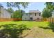 Lush backyard with a green lawn, a wooden fence, and mature trees, providing privacy and a connection with nature at 1703 Dotterers Run, Charleston, SC 29414