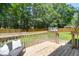 Wooden deck offering outdoor seating, privacy fence, and views of the green backyard at 1703 Dotterers Run, Charleston, SC 29414