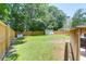 Expansive backyard with a well-maintained lawn, a wooden privacy fence, and a storage shed, offering outdoor space at 1703 Dotterers Run, Charleston, SC 29414