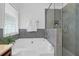 Bathroom featuring a tub, a glass-enclosed shower, and a window providing ample light at 1703 Dotterers Run, Charleston, SC 29414
