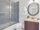 Cozy bathroom featuring a shower with sliding glass doors, a wood vanity, and a decorative framed mirror at 1703 Dotterers Run, Charleston, SC 29414