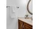 Well-lit bathroom featuring a vanity with a round mirror, neutral countertop and a decorative flower pot at 1703 Dotterers Run, Charleston, SC 29414