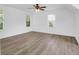 Large bedroom with hardwood floors, white walls, and windows providing natural light at 1703 Dotterers Run, Charleston, SC 29414