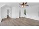 Spacious bedroom featuring wood-look floors, a ceiling fan, and three windows, providing ample natural light at 1703 Dotterers Run, Charleston, SC 29414