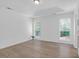 Bright bedroom with hardwood floors and two windows providing ample natural light at 1703 Dotterers Run, Charleston, SC 29414