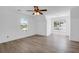 Well-lit bedroom with wood-look floors, three windows, and a ceiling fan, offering a comfortable and bright space at 1703 Dotterers Run, Charleston, SC 29414