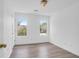 Bright bedroom featuring wood-look flooring, fresh paint and natural light from two windows overlooking the neighborhood at 1703 Dotterers Run, Charleston, SC 29414