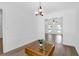 Dining room with a chandelier, hardwood floors, and large windows at 1703 Dotterers Run, Charleston, SC 29414