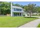 Two-story home with a front porch, established trees, and a well-manicured lawn at 1703 Dotterers Run, Charleston, SC 29414