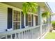 Inviting front porch with ferns, chairs, and curb appeal to welcome all visitors at 1703 Dotterers Run, Charleston, SC 29414
