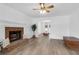 Cozy living room with fireplace, hardwood floors and windows with natural light at 1703 Dotterers Run, Charleston, SC 29414
