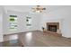 Bright living room with a brick fireplace, hardwood floors, and large windows at 1703 Dotterers Run, Charleston, SC 29414