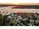 Aerial view showcasing waterfront homes with private docks and lush surroundings during sunset at 1720 Bowline Dr, Mount Pleasant, SC 29466