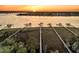Aerial view showcasing multiple docks extending into a tranquil body of water at sunset at 1720 Bowline Dr, Mount Pleasant, SC 29466