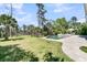 Expansive backyard with a luxurious pool, lush lawn, and mature trees at 1720 Bowline Dr, Mount Pleasant, SC 29466