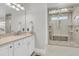 Well-lit bathroom featuring a vanity and frameless shower with a built-in bench and multiple shower heads at 1720 Bowline Dr, Mount Pleasant, SC 29466