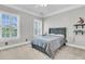 Neutral bedroom with plantation shutters, bed, and decorative shelving at 1720 Bowline Dr, Mount Pleasant, SC 29466