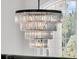 Close-up of a modern crystal chandelier hanging in front of a large window at 1720 Bowline Dr, Mount Pleasant, SC 29466
