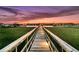 Picturesque sunset view from a private dock leading out to the serene waterway at 1720 Bowline Dr, Mount Pleasant, SC 29466