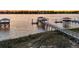 Scenic view of a private boat dock and pier extending into the water at sunset at 1720 Bowline Dr, Mount Pleasant, SC 29466