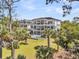Three-story home with balconies, large backyard, inground pool, and mature landscaping at 1720 Bowline Dr, Mount Pleasant, SC 29466