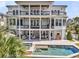 Back exterior of a three story home featuring porches, a pool, and outdoor entertaining area at 1720 Bowline Dr, Mount Pleasant, SC 29466