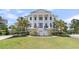Elegant, two-story home featuring classic columns, a manicured lawn, and lush landscaping at 1720 Bowline Dr, Mount Pleasant, SC 29466
