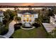 Elegant two-story home boasts grand columns, a landscaped yard, and a serene waterfront view at sunset at 1720 Bowline Dr, Mount Pleasant, SC 29466
