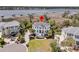 Expansive estate boasts a manicured lawn, mature landscaping, and views of the waterway and community docks at 1720 Bowline Dr, Mount Pleasant, SC 29466