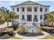 Elegant two-story home boasts grand columns, black trim, and a welcoming front porch with rocking chairs at 1720 Bowline Dr, Mount Pleasant, SC 29466
