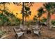 Cozy outdoor fire pit area surrounded by Adirondack chairs and lush palm trees at 1720 Bowline Dr, Mount Pleasant, SC 29466